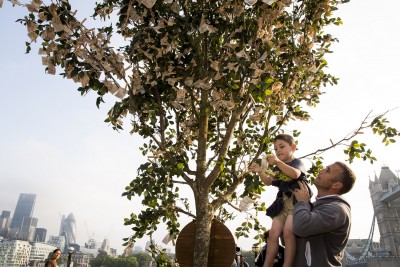 LONDON, ENGLAND - JULY 24:  Londoners walking through Potters Field Park were surprised to see a 'money tree'  blooming with £9820 in £10 notes, the average amount a working British family has in savings, on July 24, 2014 in London, England. The tree was planted by Sunlife to encourage the nation to start saving at least £10 a month for a brighter future.  (Photo by Tristan Fewings/Getty Images for SunLife)